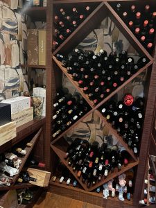 Custom wine rack designed by Paarl interior decorators, featuring a stylish wooden structure inspired by local winelands. The wine storage seamlessly blends earthy tones and natural textures, bringing the rustic elegance of Paarl's wineland landscapes into a home decor setting.