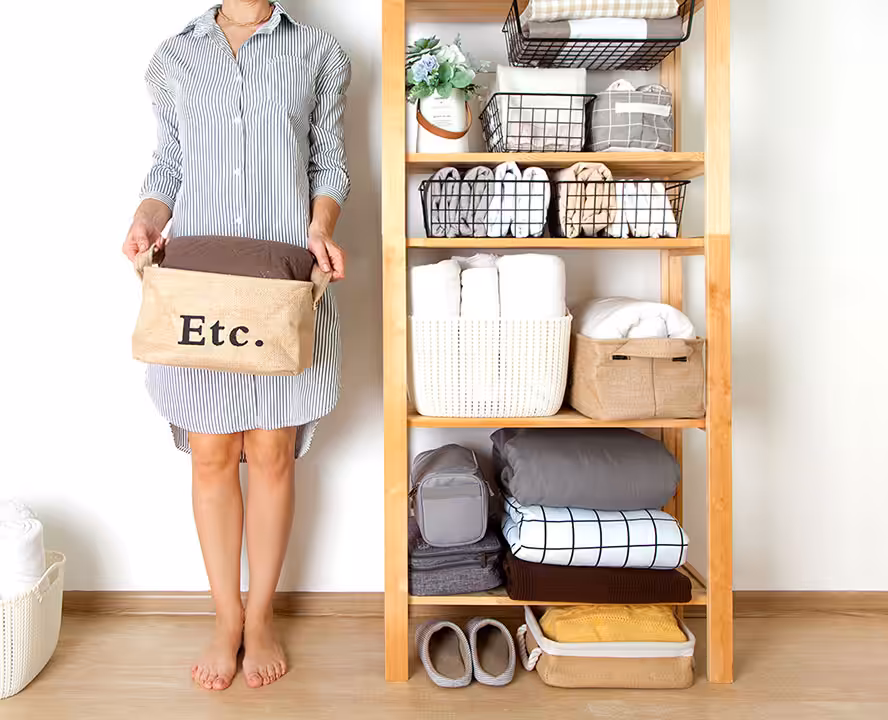 Neatly organized shelf with storage baskets, highlighting the expertise of professional organizers in creating clutter-free spaces.
